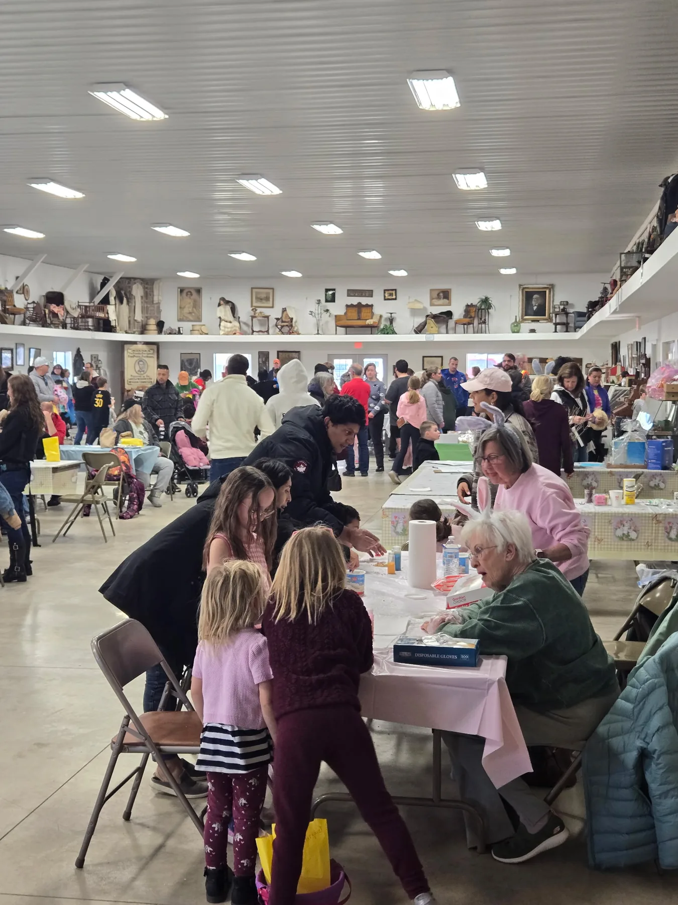 Children and volunteers working at an Easter craft table