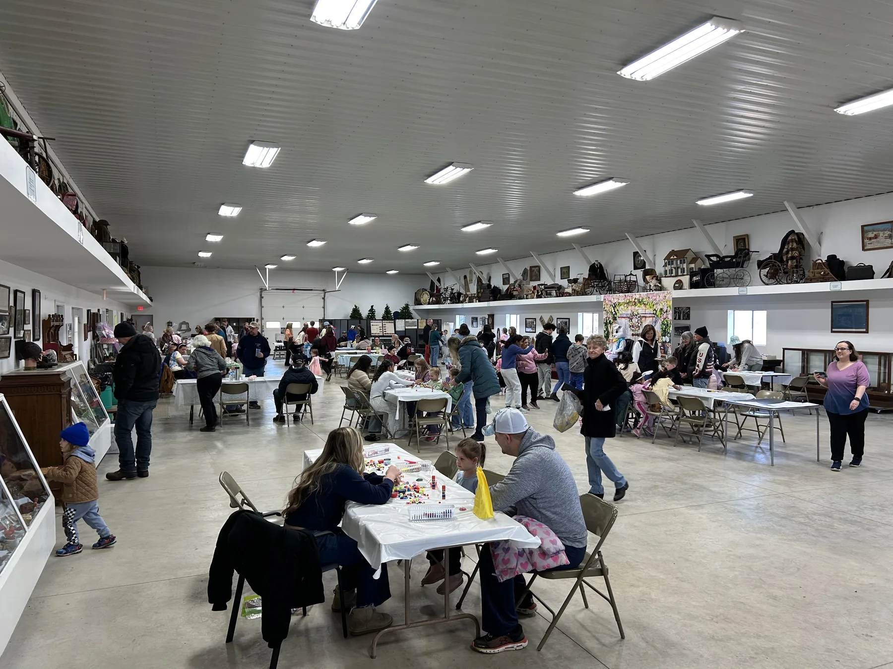 Families enjoying Easter activities inside the Lyon Farm event hall